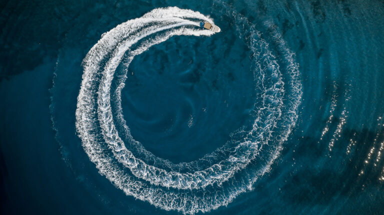 A boat sails in a circle, leaving a spherical wake