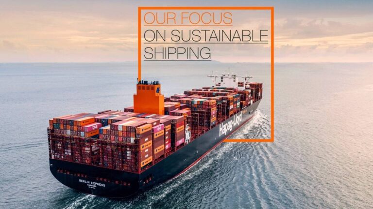 An aerial shot of a freight ship on the sea, with the words "Our focus on sustainable shipping" on the horizon.