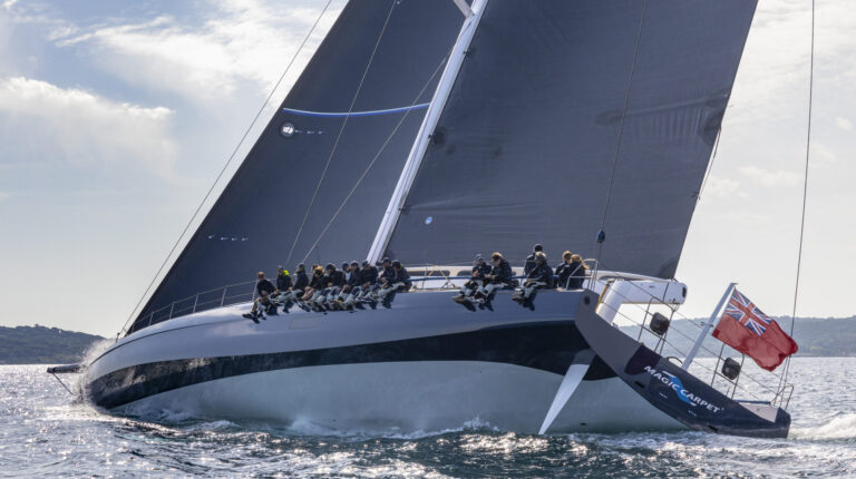 Helix develops electric motor technologies for Magic Carpet e yacht, shown here with sailors sat on the port side of the vessel as it makes a turn.
