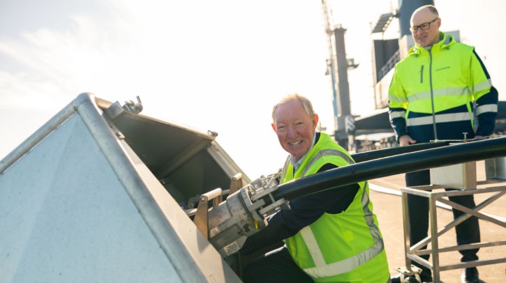 Nelson Mayor Nick Smith, pictured in a yellow high-vis jacket, officially turns the power on for New Zealand's first electric mobile harbor crane