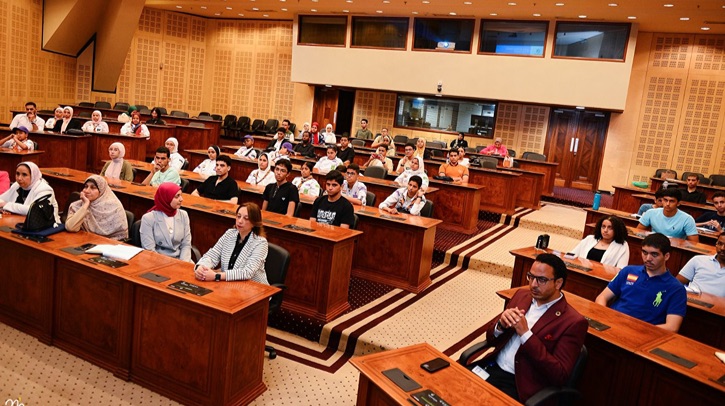 A discussion hall filled with seated people