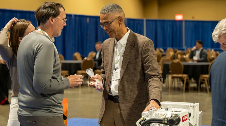 Two men smile while locked in conversation