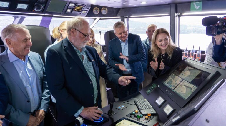 Company representatives of Incat Tasmania stand on the bridge of the world’s largest battery-electric ship, Hull 096.