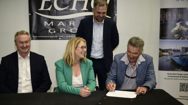 Representatives of the Western Australia government and Echo Marine Group sit at a table and sign a. ontract for the construction of the state's first electric ferries