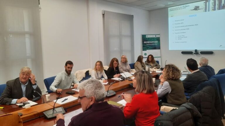 The Ecoport II working group meets to discuss 2025 outcomes and future plans. Members sit around a table in smart casual attire with a projector screen at one end of the room.