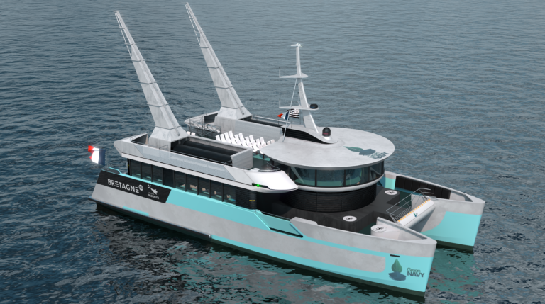 A grey ship with Green Navy company naming on the hull and deck sails through a calm, grey sea.