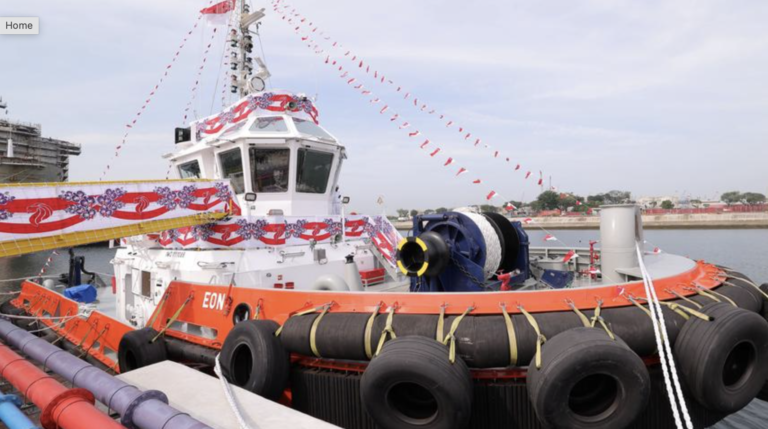 First fully electric harbor tug in Southeast Asia delivered The Eon tug, which has a white superstructure and a black and orange hull.
