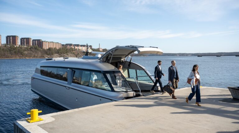 Candela unveils electric hydrofoil vessel targeting premium water transportation market The Candela P13 electric hydrofoil vessel parked at a dock with passengers waiting to get on.