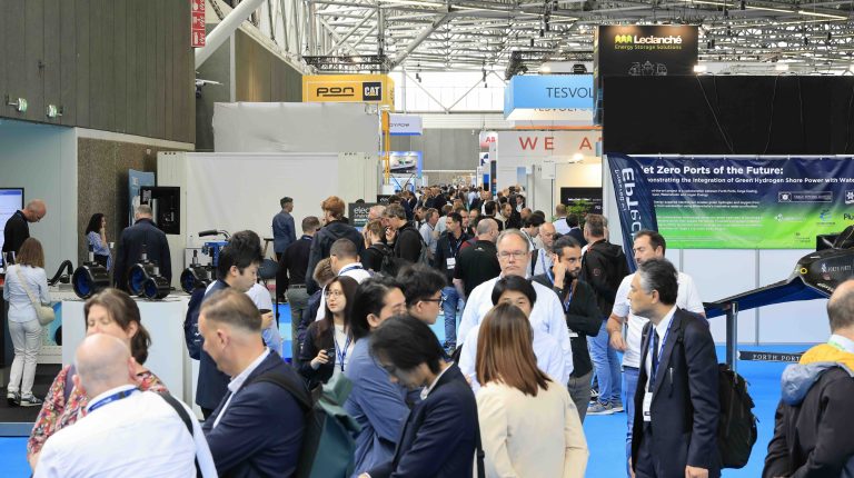 The show floor at the Advanced Maritime Technology Expo & Conference trade show, with attendees looking at exhibits and holding discussions.