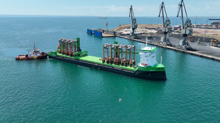 Port of Thessaloniki adds eight hybrid straddle carriers to boost capacity Aerial view of the Port of Thessaloniki with a green container ship in the foreground a cranes in the distance.