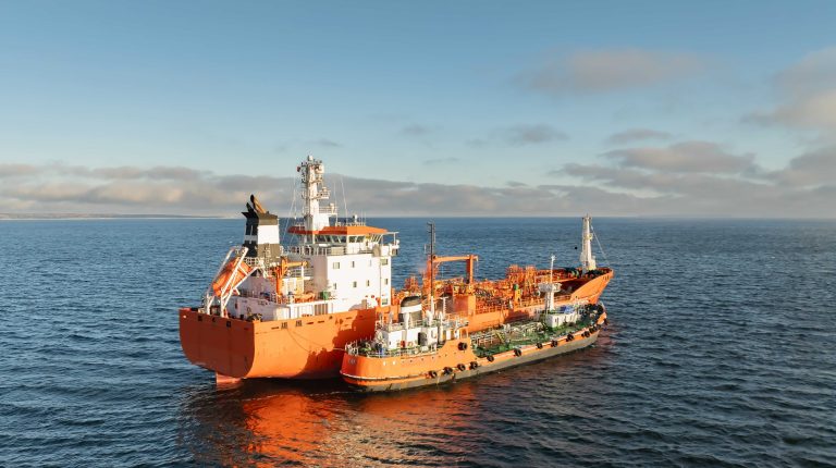UK Chamber of Shipping publishes safety evidence base for alternative marine fuels Aerial drone view of orange chemical tanker ship bunkering and refueling from a smaller bunker vessel in the Baltic Sea
